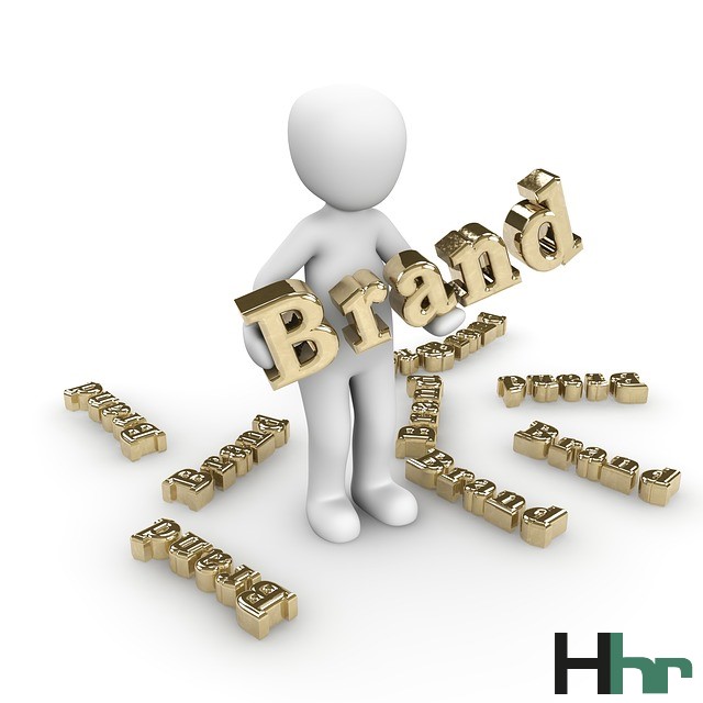 white figure holding word Brand in gold letters, some on the floor