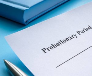 Sheet of paper with the inscription probationary period lies on the table.